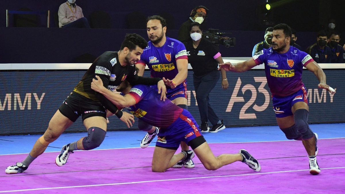Ankit Beniwal of Telugu Titans is tackled by the Dabang Delhi K.C. defenders in Match 128 of VIVO Pro Kabaddi League Season 8
