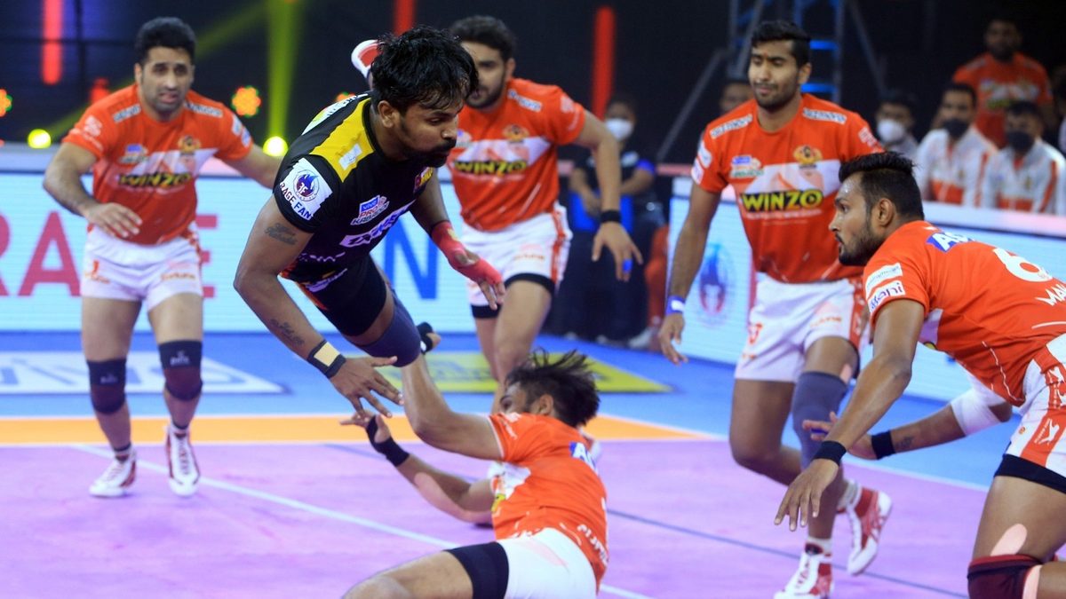 Bengaluru Bulls' Chandran Ranjith leaps over the Gujarat Giants' defenders in Eliminator 2 of VIVO Pro Kabaddi League Season 8