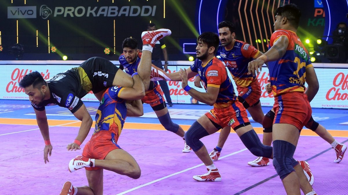 Adarsh of Telugu Titans jumps over the U.P. Yoddha defenders in Match 96 of VIVO Pro Kabaddi League Season 8