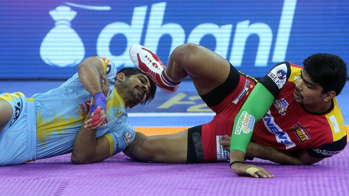 Pawan Sehrawat of Bengaluru Bulls sneakily gets a point off Sumit of U.P. Yoddhas in Match 87 of VIVO Pro Kabaddi League Season 8
