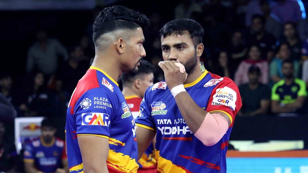 U.P. Yoddha’s Rishank Devadiga and Monu Goyat discuss tactics during the game against U Mumba.