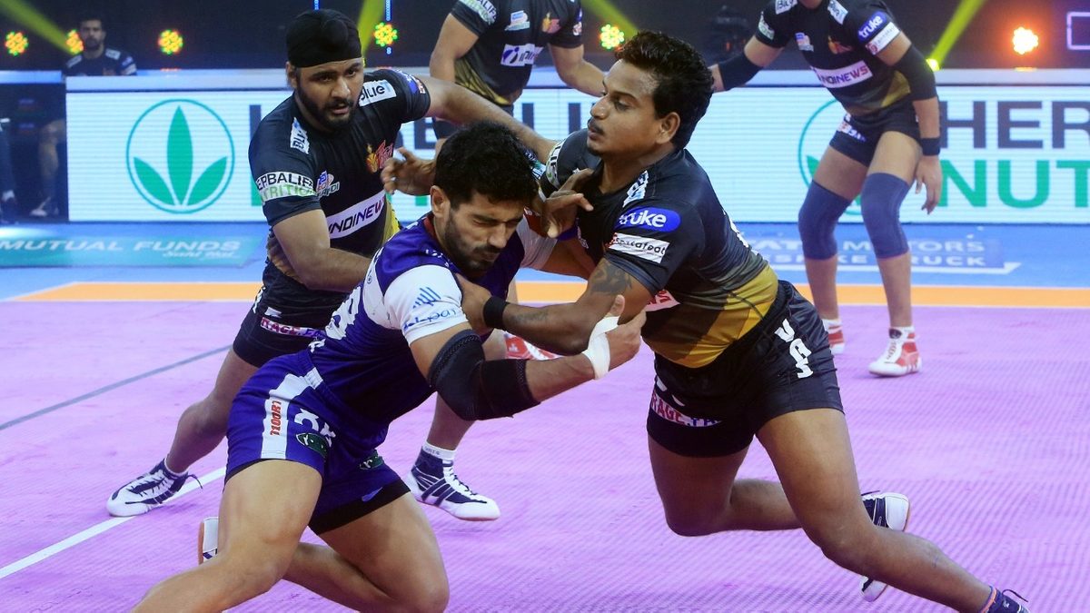 Haryana Steelers' raider Vikash Kandola is tackled by Telugu Titans' defence in Match 77 of VIVO Pro Kabaddi League Season 8.