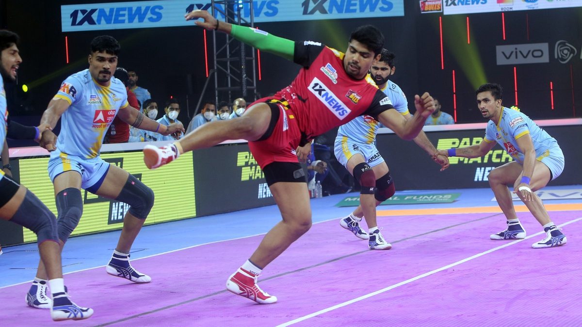 Pawan Sehrawat of Bengaluru Bulls looks to kick his way through the U.P. Yoddhas' defense in Match 87 of VIVO Pro Kabaddi League Season 8