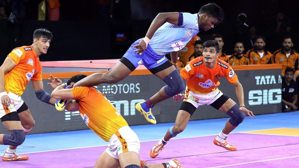 V Ajith Kumar leaps above a Puneri Paltan defender. 