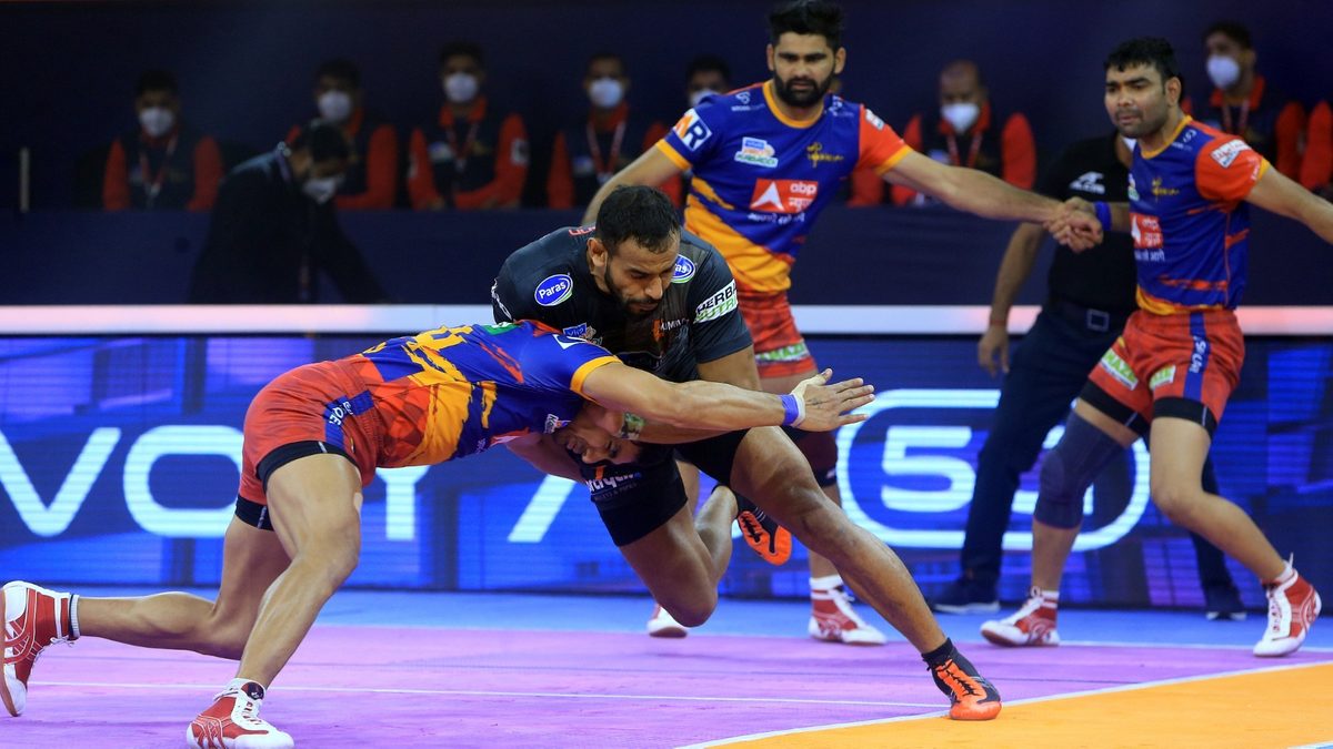 Abhishek Singh of U Mumba dashes into a tackle from the U.P. Yoddha defender in Match 124 of VIVO Pro Kabaddi League Season 8