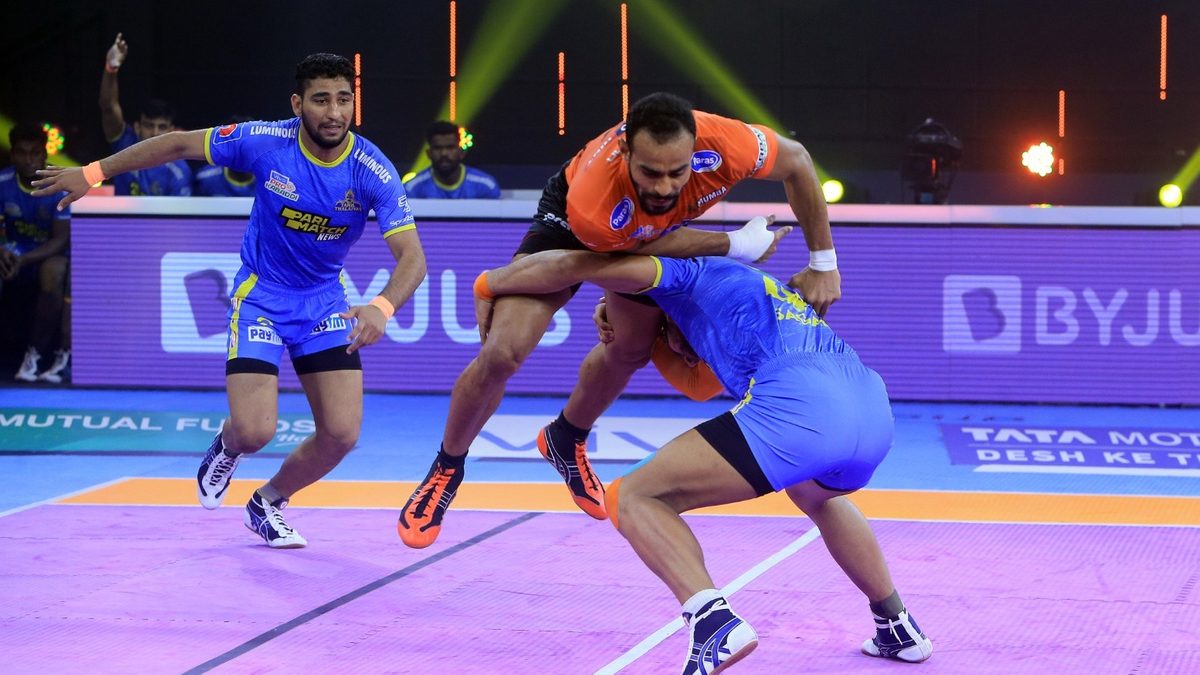 Abhishek Singh of U Mumba tries to jump over the Tamil Thalaivas' defenders in Match 95 of VIVO Pro Kabaddi League Season 8