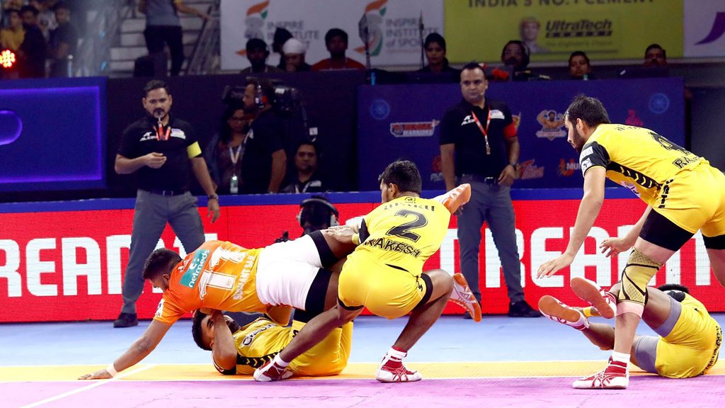 Puneri Paltan’s Sushant Sail hurdles over two Telugu Titans defenders for a Super Raid.