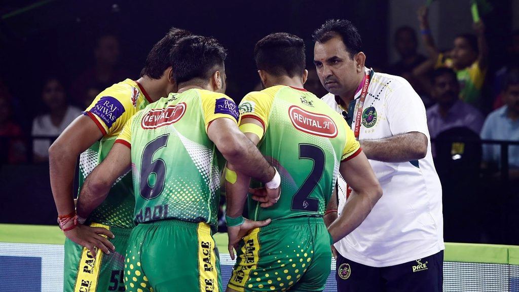 Patna Pirates coach Ram Mehar Singh talks to his players during the game.