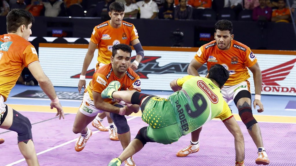 Puneri Paltan skipper Surjeet Singh attempts a tackle on Pardeep Narwal.