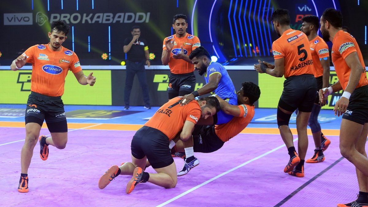 Ajinkya Pawar of Tamil Thalaivas is pulled back by the U Mumba defenders in Match 95 of VIVO Pro Kabaddi League Season 8