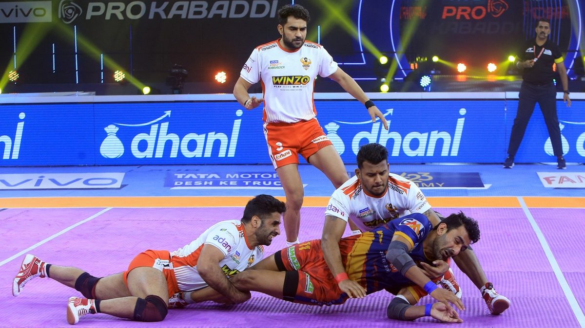 Hadi Oshtorak and Girish Ernak of Gujarat Giants stop Surender Gill of U.P. Yoddha from reaching the center line in Match 115 of VIVO Pro Kabaddi League Season 8