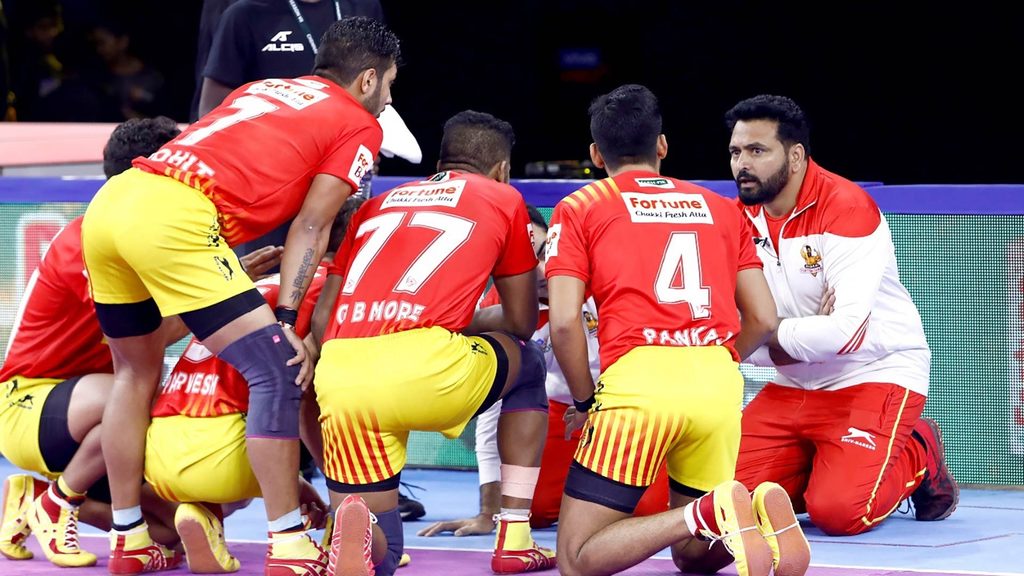 Gujarat Fortunegiants’ coach Manpreet Singh gives his players instructions.  