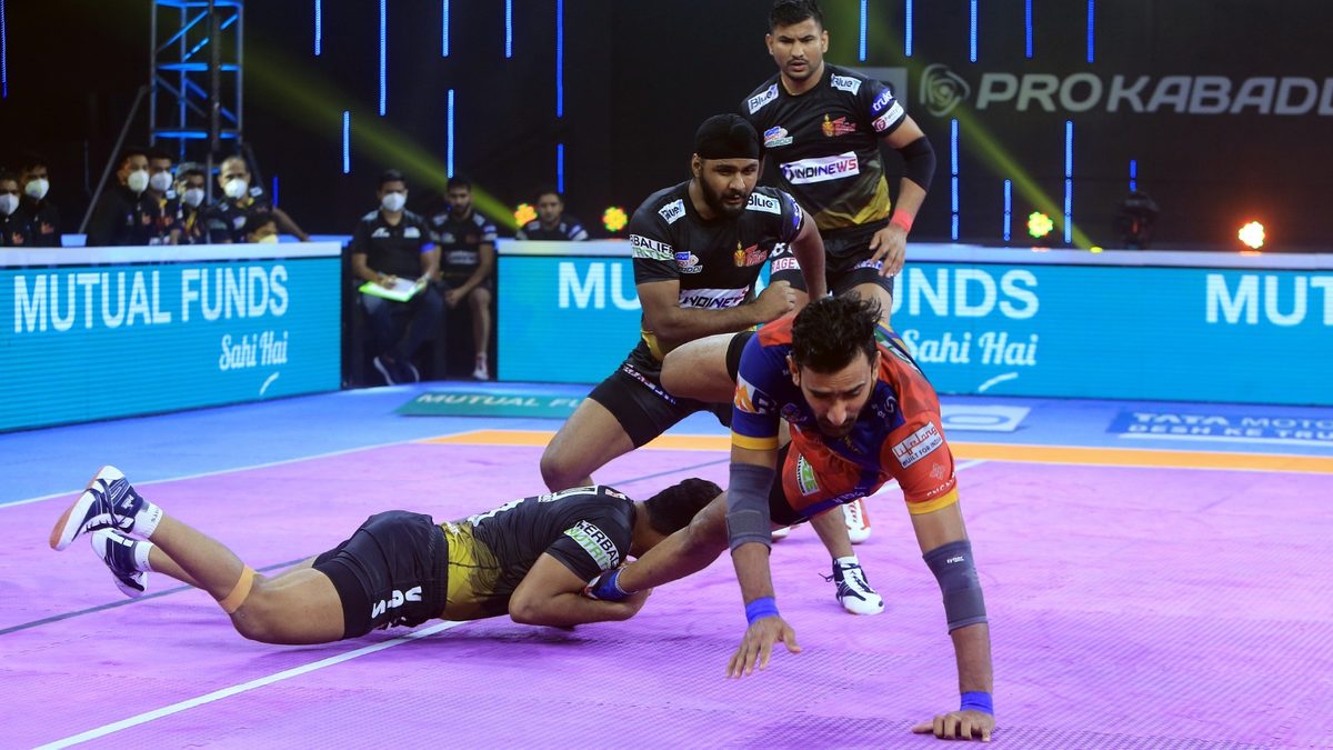 Surender Gill of U.P. Yoddha is grabbed by the Telugu Titans defenders in Match 96 of VIVO Pro Kabaddi League Season 8