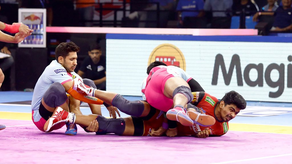 Pawan Sehrawat gets tackled by the Jaipur Pink Panthers’ defence in Panchkula.
